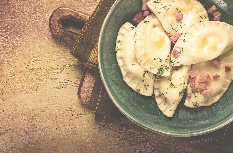 Dumplings, with fried prosciutto, a traditional dish of Polish cuisine, dumplings, top view, close-up, without people