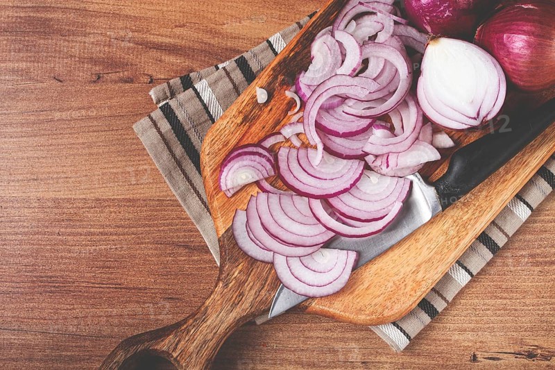 Sliced red onion, on a chopping board, with a knife, Spanish onion, raw onion, close-up, top view