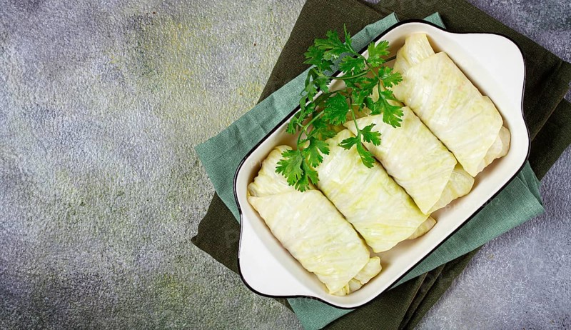 Raw cabbage rolls, not cooked, with minced meat, top view, without people, in the spotlight