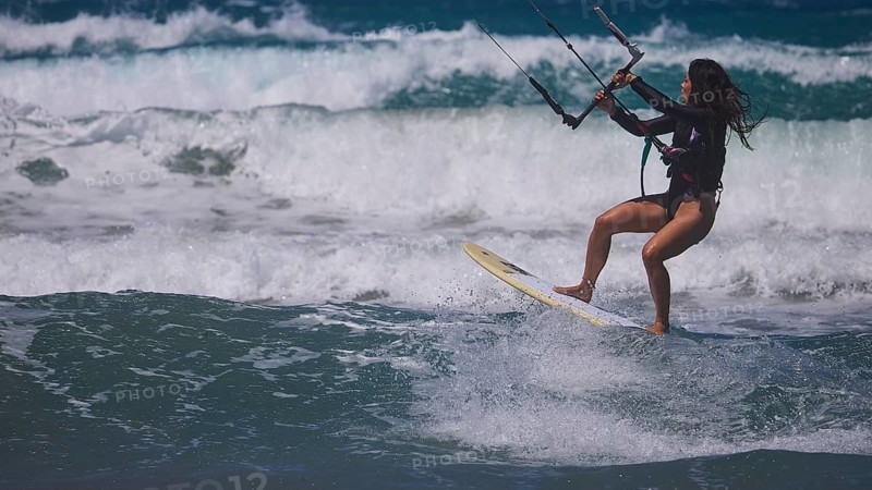 Woman kitesurfing sportily over the waves under a clear sky, Prasonisi, beach, surf, windsurfer, kite surfer, waves, south coast, Rhodes, Dodecanese, Greek Islands, Greece