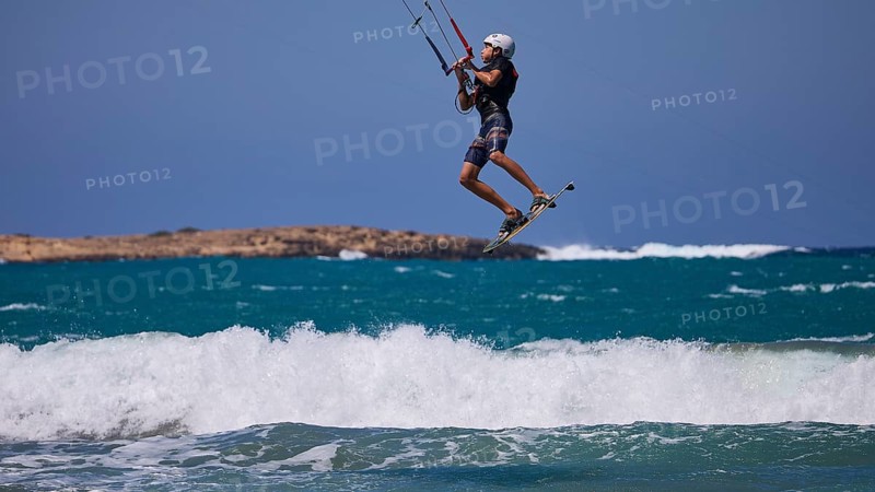 Kitesurfer in the air jumping over the waves in sunny weather, Prasonisi, beach, surf, windsurfer, kite surfer, waves, south coast, Rhodes, Dodecanese, Greek Islands, Greece