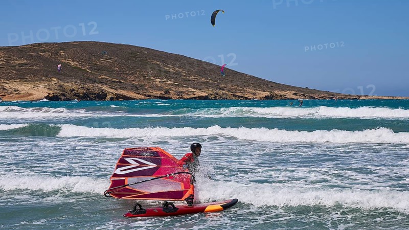 Windsurfer on the water with vivid colours and clear sky, Prasonisi, beach, surf, windsurfer, kite surfer, waves, south coast, Rhodes, Dodecanese, Greek Islands, Greece