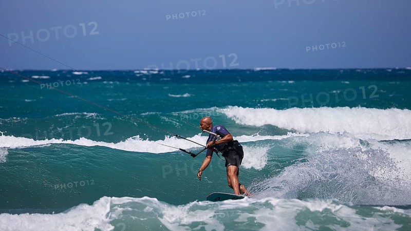 Kitesurfer gliding over the waves in sunny weather and blue sky, Prasonisi, beach, surf, windsurfer, kite surfer, waves, south coast, Rhodes, Dodecanese, Greek Islands, Greece