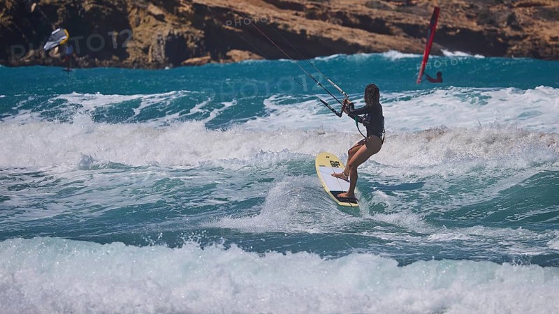 Kitesurfer skilfully navigates the waves off the rocky coast, Prasonisi, beach, surf, windsurfer, kite surfer, waves, south coast, Rhodes, Dodecanese, Greek Islands, Greece