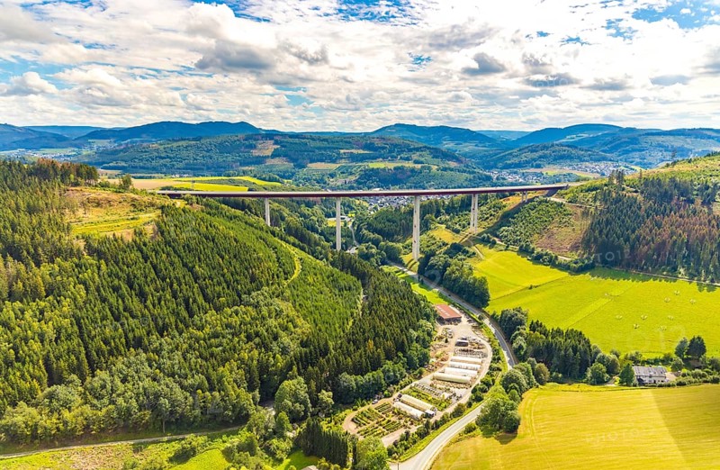 Aerial view, Nuttlar viaduct, motorway A46, Garten- und Landschaftsbau Hans-Gerd Meschede KG, Bestwig, Sauerland, North Rhine-Westphalia, Germany, view to Nuttlar, bridge, DE, Europe, commercial enterprises, commercial area, industrial area, commercial location, commercial use, hilly landscape, industrial area, industrial site, aerial view, aerial photography, aerial photography, Rüthener Straße, valley bridge Nuttlar A46, overview, bird's-eye view, forest, forest area, meadows and fields, birds-eyes view, overview