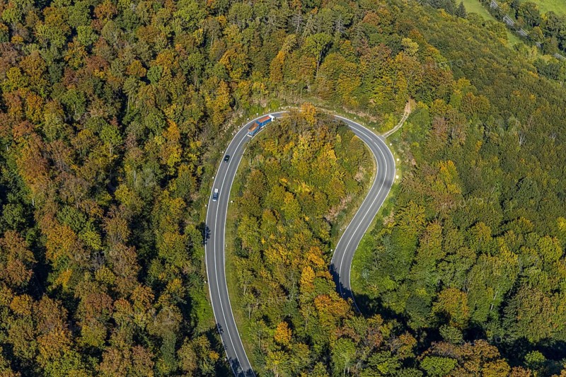 Aerial view, serpentine road in forest area, north of Jakobsberg, Beverungen, East Westphalia-Lippe, North Rhine-Westphalia, Germany, DE, Europe, autumn colours, state road L838, aerial view, aerial photography, aerial photography, OLWBUCH, OWL, OWL-Buch, East Westphalia, serpentine shape, road traffic, overview, bird's-eye view, birds-eyes view, autumn forest, overview