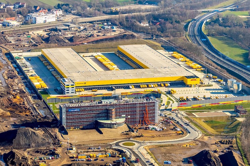 Aerial view, MARK 51Â°7 industrial estate, new construction DHL logistics parcel centre, former Opel site, Laer district, Bochum, Ruhr area, North Rhine-Westphalia, Germany, expansion areas, A448 motorway, construction, construction area, construction site, construction project, construction site, DEU, DHL, DHL logistics, DHL parcel centre, earthworks, Renewal, development, Europe, Mark 51/7 industrial estate, capacity requirements, logistics, aerial view, aerial photography, aerial photography, new build, Opel site, Opelring 1, overview, bird's-eye view, growth, becoming and growing, birds-eyes view, former Opel site with old administration building, overview