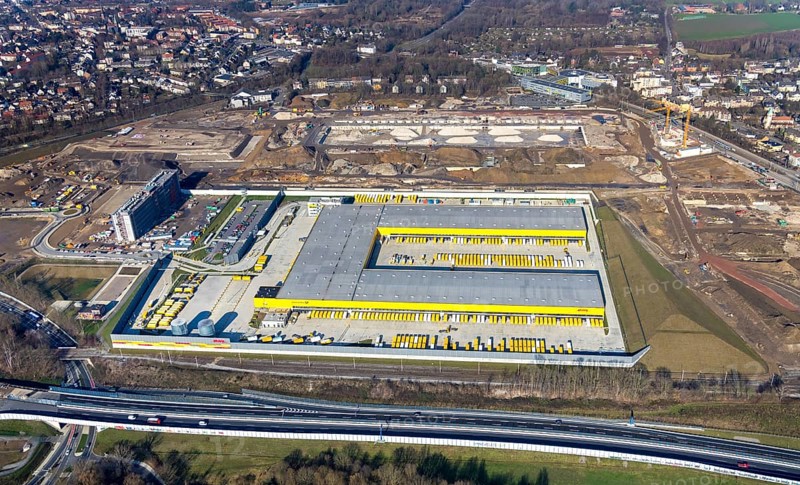 Aerial view, MARK 51Â°7 industrial estate, new construction DHL logistics parcel centre, former Opel site, Laer district, Bochum, Ruhr area, North Rhine-Westphalia, Germany, expansion areas, A448 motorway, construction, construction area, construction site, construction project, construction site, DEU, DHL, DHL logistics, DHL parcel centre, earthworks, Renewal, development, Europe, Mark 51/7 industrial estate, capacity requirements, logistics, aerial view, aerial photography, aerial photography, new build, Opel site, Opelring 1, overview, bird's-eye view, growth, becoming and growing, birds-eyes view, former Opel site with old administration building, overview