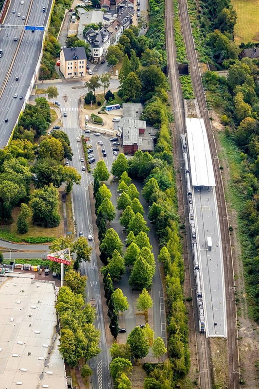 Aerial view, Wattenscheid railway station, motorway exit Bochum-Wattenscheid, Westenfeld, Bochum, Ruhr area, North Rhine-Westphalia, Germany, motorway A40, railway tracks, railway station, station forecourt, Bochum-Wattenscheid, DE, Deutsche Bahn AG, Europe, green trees, main station, aerial view, aerial photography, aerial photography, Wattenscheid district, overview, bird's eye view, Wattenscheid, birds-eyes view, overview