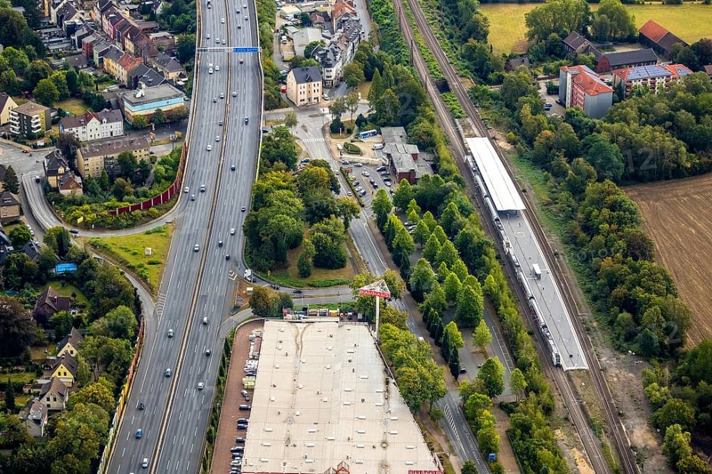 Aerial view, Wattenscheid railway station, motorway exit Bochum-Wattenscheid, Westenfeld, Bochum, Ruhr area, North Rhine-Westphalia, Germany, motorway A40, railway tracks, railway station, station forecourt, Bochum-Wattenscheid, DE, Deutsche Bahn AG, Europe, green trees, main station, aerial view, aerial photography, aerial photography, Wattenscheid district, overview, bird's eye view, Wattenscheid, birds-eyes view, overview