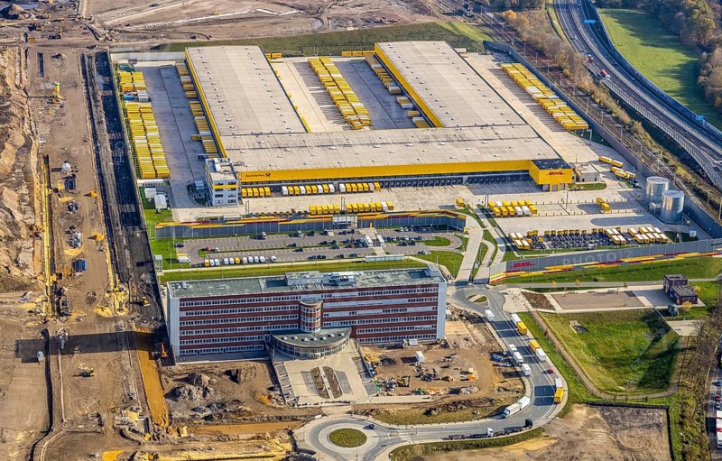Construction site, new construction DHL Logistik, former Opel site, former Opel administration building, Laer, Bochum, North Rhine-Westphalia, Germany, expansion areas, construction work, building plots, construction measure, DE, monument protection, earthworks, renewal, development, Europe, commercial enterprises, commercial area, commercial park, commercial site, commercial use, freight transport, industrial area, industrial building, industrial site, capacity requirements, logistics, logistics service, logistics service provider, logistics provider, logistics centre, aerial view, aerial photograph, aerial photography, aerial photography, MARK 51°7, Mark 51/7, Opelring, Ruhr area, freight forwarding, transport, transport service, overview, bird's-eye view, growth, becoming and growing, birds-eyes view, overview