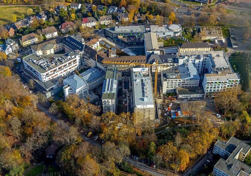 Construction site at St. Josef Hospital Bochum with trees in autumn colours, Bochum, Ruhr area, North Rhine-Westphalia, Germany, construction, construction area, construction site, building plots, construction project, construction site, trees in autumn colours, DE, DEU, development, Europe, healthcare, autumn colours, hospital, clinic, clinic centre, hospital, aerial view, aerial photograph, aerial photography, aerial photography, medical facility, medical aid, overview, bird's eye view, birds-eyes view, overview, medical care