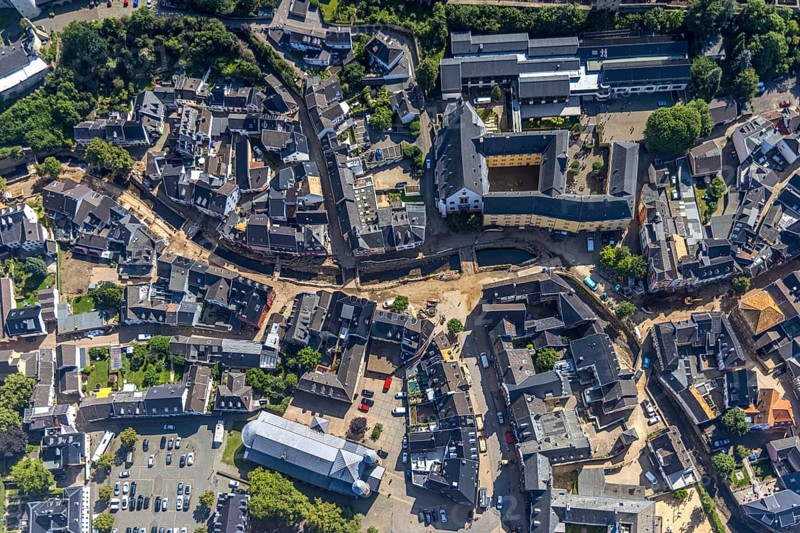Aerial view, historic old town with St. Donatus-Jesuit church and St. Michael-Gymnasium as well as collegiate church St. Chrysanthus and Daria and Bad Münstereifel town hall with destroyed bank area of the Erft after the Erft flood in Bad Münstereifel, Ahr flood, Ahr valley, North Rhine-Westphalia, Germany, place of worship, Bad Münstereifel, authority, education, educational institution, DE, Europe, flood disaster, religious community, place of worship, property tax, grammar school, holy place, flood disaster, real estate, flood of the century, church, parish, denomination, teaching institute, aerial view, aerial photography, aerial photography, town hall, religion, religious site, school, heavy rain, overview, bird's-eye view, living and life, residential area, residential buildings, quality of life, birds-eyes view, overview, flooding