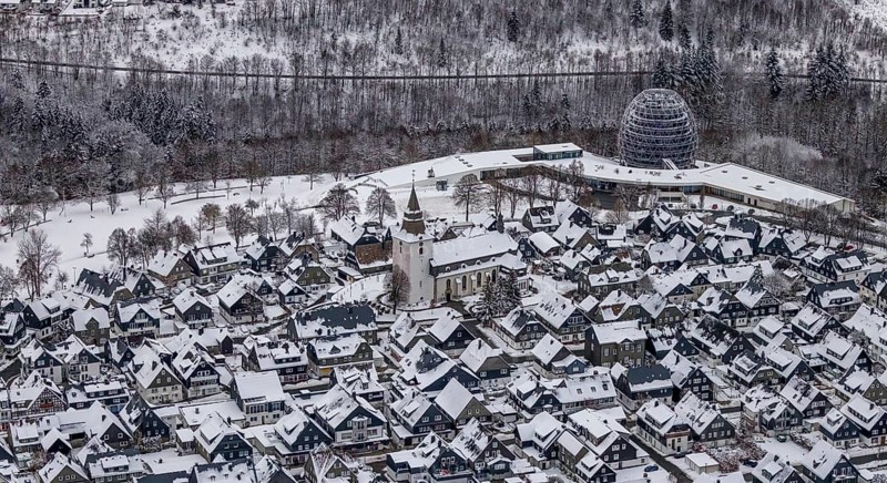 Aerial view of the snowy winter landscape of Winterberg with deserted streets during the corona lockdown in the Sauerland in North Rhine-Westphalia, Germany, Sauerland, Europe, aerial photo, birds-eyes view, aerial photography, aerial photography, overview, bird's eye view, lockdown, closed winter landscape, corona lockdown, deserted, snow, winter weather, corona-related lockdown