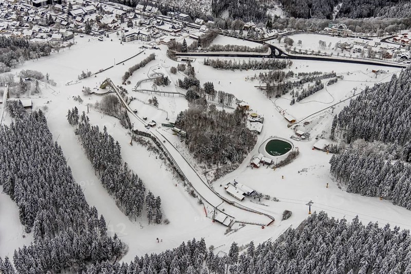Aerial view of the snowy winter landscape of Winterberg with the St. Georg ski jump in the Sauerland in North Rhine-Westphalia, Germany, Sauerland, Europe, aerial photo, birds-eyes view, aerial photography, aerial photography, overview, bird's eye view, lockdown, closed winter landscape, corona lockdown, deserted, snow, winter weather, corona-related lockdown