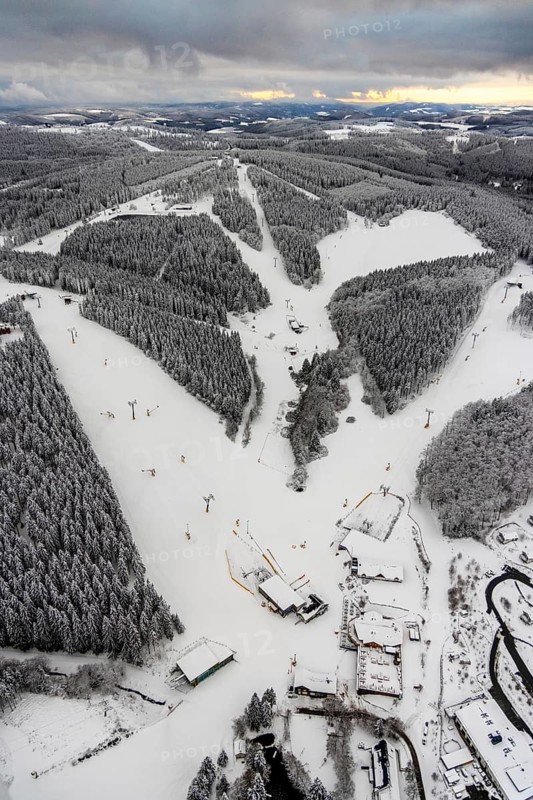 Aerial view of the snowy winter landscape of Winterberg with deserted ski lifts and slopes during the corona-related lockdown in Sauerland in North Rhine-Westphalia, Germany, Sauerland, Europe, aerial photo, birds-eyes view, aerial photography, aerial photography, overview, bird's eye view, lockdown, closed winter landscape, corona lockdown, deserted, snow, winter weather, corona-related lockdown