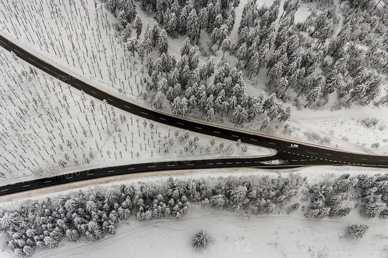 Aerial view of the snowy winter landscape of Winterberg with winding roads and paths with a V-shaped fork in the road in Sauerland in North Rhine-Westphalia, Germany, Sauerland, Europe, aerial photo, birds-eyes view, aerial photography, aerial photography, overview, bird's eye view, lockdown, closed winter landscape, corona lockdown, deserted, snow, winter weather, corona-related lockdown