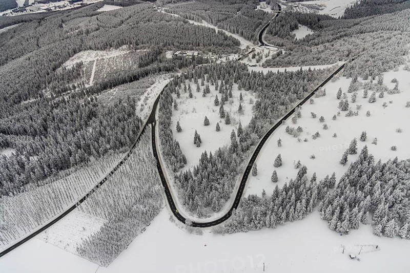 Aerial view of the snowy winter landscape of Winterberg with winding roads and paths in the Sauerland in North Rhine-Westphalia, Germany, Sauerland, Europe, aerial photo, birds-eyes view, aerial photography, aerial photography, overview, bird's eye view, lockdown, closed winter landscape, corona lockdown, deserted, snow, winter weather, corona-related lockdown
