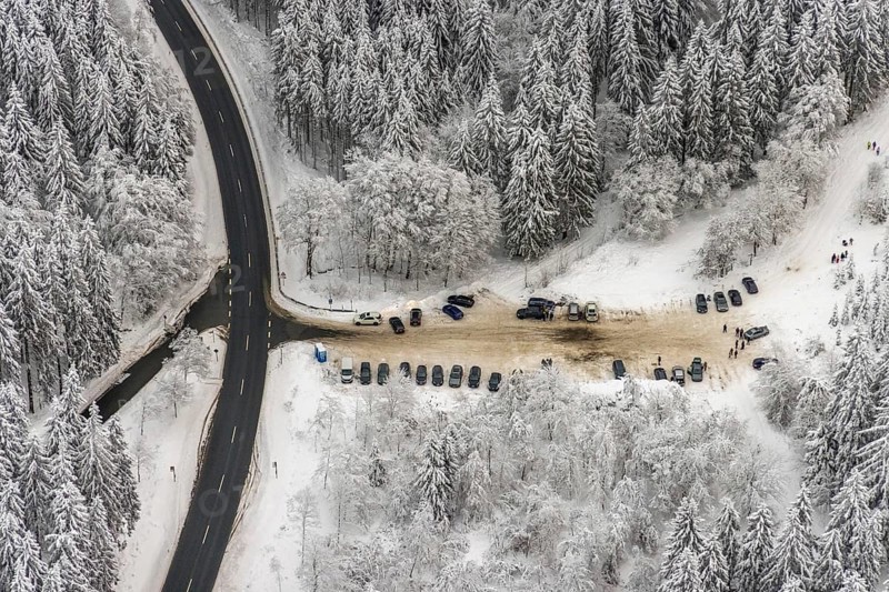 Aerial view of the snowy winter landscape of Winterberg with car park Helleplatz at Kahlen Asten in Sauerland in North Rhine-Westphalia, Germany, Sauerland, Europe, aerial view, birds-eyes view, aerial photography, aerial photography, overview, bird's eye view, lockdown, closed winter landscape, corona lockdown, deserted, snow, winter weather, corona-related lockdown