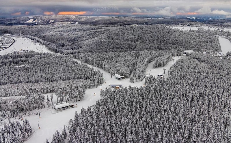 Aerial view of the snowy winter landscape of Winterberg with deserted ski lifts and slopes during the corona-related lockdown in the Sauerland in North Rhine-Westphalia, Germany, Sauerland, Europe, aerial photo, birds-eyes view, aerial photography, aerial photography, overview, bird's eye view, lockdown, closed winter landscape, corona lockdown, deserted, snow, winter weather, corona-related lockdown, high heath in winter