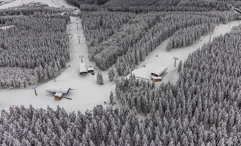 Aerial view of the snowy winter landscape of Winterberg with deserted ski lifts and slopes during the corona-related lockdown in the Sauerland in North Rhine-Westphalia, Germany, Sauerland, Europe, aerial photo, birds-eyes view, aerial photography, aerial photography, overview, bird's eye view, lockdown, closed winter landscape, corona lockdown, deserted, snow, winter weather, corona-related lockdown, high heath in winter