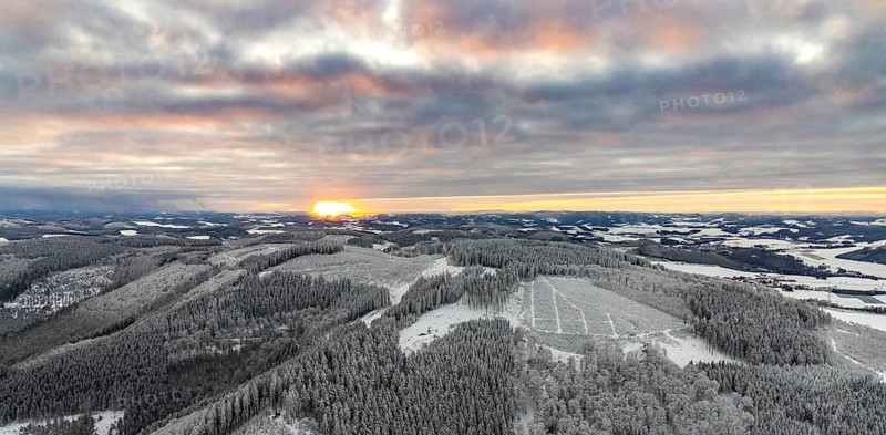 Aerial view of the sunset with a view over the snowy winter landscape from Winterberg to the Bergisches Land in Sauerland in North Rhine-Westphalia, Germany, Sauerland, Europe, aerial view, birds-eyes view, aerial photography, aerial photography, overview, bird's eye view, lockdown, closed winter landscape, corona lockdown, deserted, snow, winter weather, corona-related lockdown