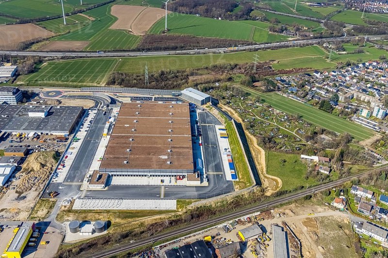 Aerial view, construction site new building Amazon logistics centre, industrial estate on Brauckstraße, allotment garden site Mellmausland, Rüdinghausen, Witten, Ruhr area, North Rhine-Westphalia, Germany, Amazon logistics centre, railway tracks, construction work, construction area, building site, building plots, construction measure, construction project, building site, DE, Ennepe-Ruhr district, development, Europe, community garden, commercial enterprises, commercial area, commercial park, commercial site, commercial use, freight traffic, industrial estate, industrial building, industrial site, allotment garden, allotment garden site, allotment garden association, allotment gardener association, logistics, logistics service, logistics provider, logistics centre, aerial view, aerial photography, aerial photography, Menglinghauser Straße, new build, parcel delivery, Salinger Feld, allotment garden, freight forwarding, transport, transport service, overview, bird's-eye view, overview