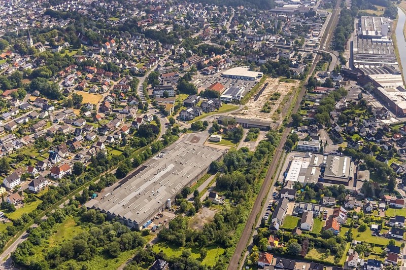 Aerial view, Edeka and Aldi supermarket, redevelopment of the brownfield site Bernhard-farmer-Park for new residential development, Mannesmann Precision Tubes GmbH Wickede plant, Wickede, Sauerland, North Rhine-Westphalia, Germany, DE, shopping markets, shopping centre, Europe, commercial enterprises, commercial area, commercial area, commercial park, commercial location, commercial use, industrial area, industrial building, industrial location, aerial view, aerial photography, aerial photography, Marscheidstraße, local supply centre, parking, supermarket, overview, bird's-eye view, overview