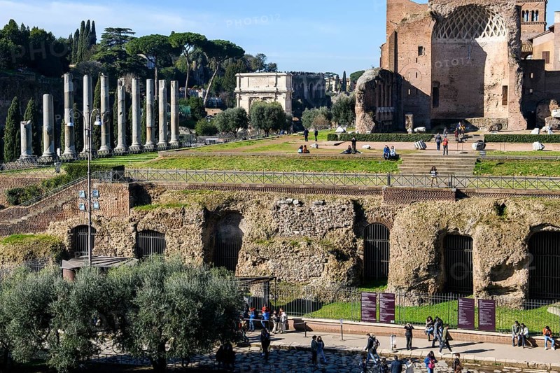 Foundations of the substructure of the Temple of Venus and Roma, Arch of Titus on the left in the background, Rome, Lazio, Italy