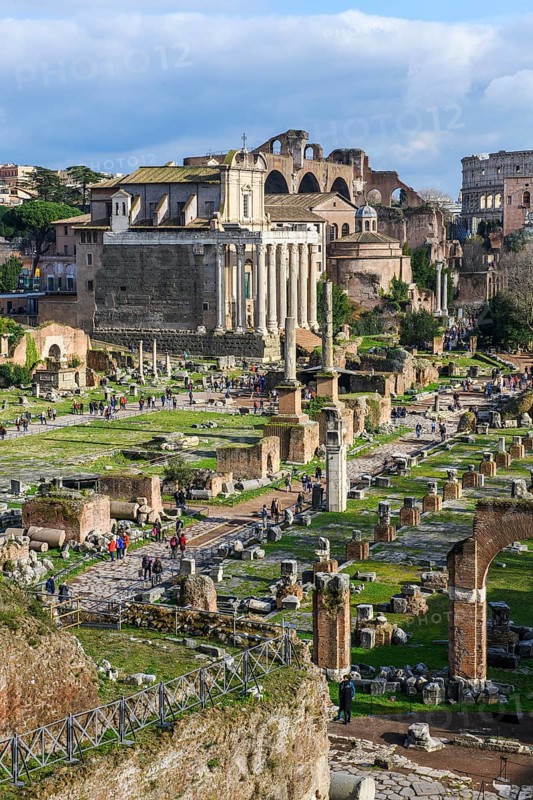 View of the central square of the Roman Forum in the left half of the picture, to the right remains of the columned walls of the Basilica Julia Giulia, in the background the former temple of Antoninus and Faustina with 17 columns made of Cipollin marble from antiquity, since the 11th century part of the Roman Catholic church of San Lorenzo in Miranda, Roman Forum, Rome, Lazio, Italy