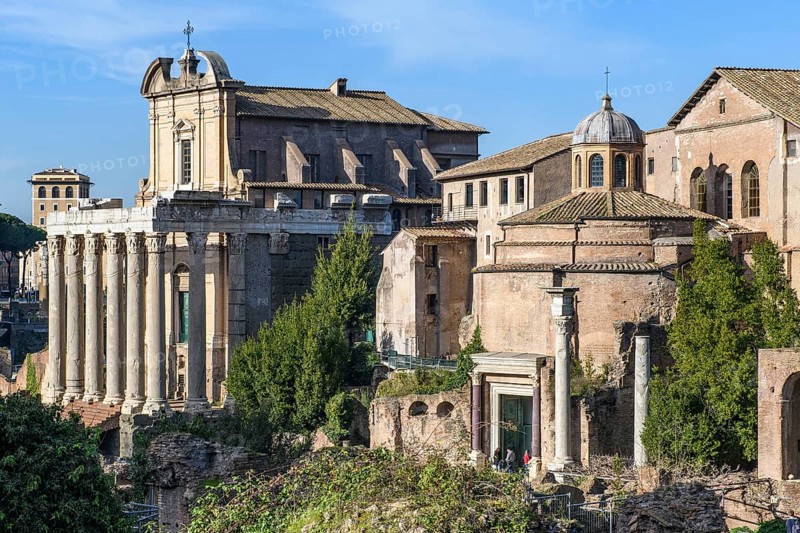 View to the left of 17 columns of Cipollin marble from the temple of Antoninus and Faustina from antiquity, part of the Roman Catholic church of San Lorenzo in Miranda since the 11th century, in the right half of the picture the temple of Romulus from antiquity, Roman Forum, Rome, Lazio, Italy