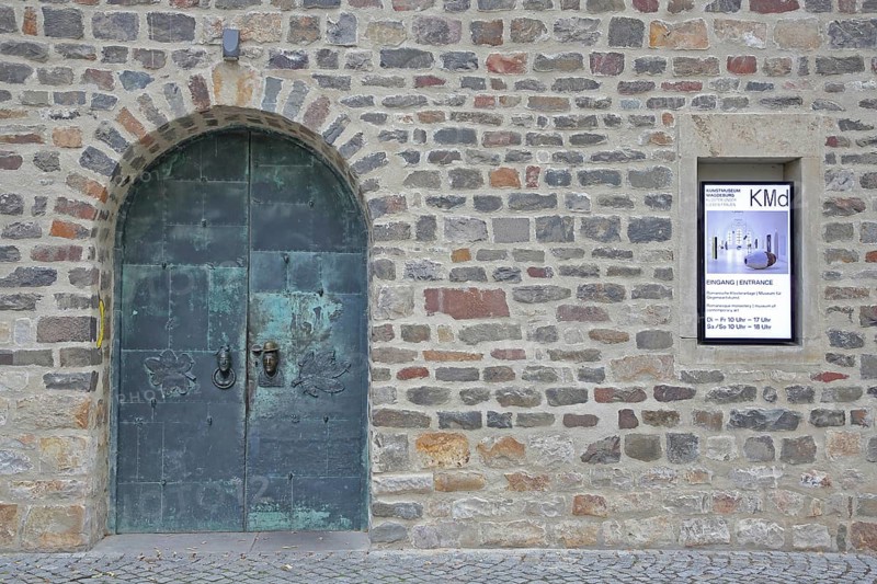 Door and entrance to the art museum, metal door, banner, stone wall, art museum, Kloster Unser Lieben Frauen, Magdeburg, Romanesque Road, Saxony-Anhalt, Germany