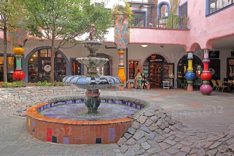 Inner courtyard with fountain and colourful columns, Green Citadel, Hundertwasser House, Magdeburg, Saxony-Anhalt, Germany