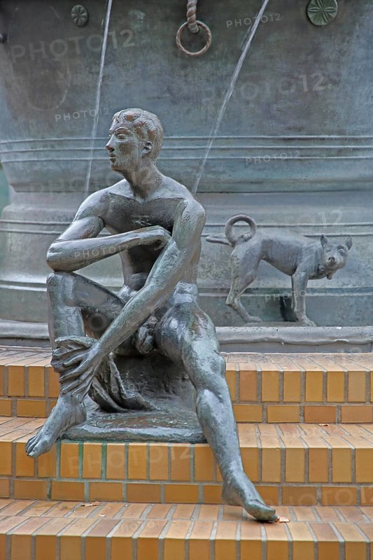 Detail with naked seated male figure and dog figure peeing at the Faun Fountain by Heinrich Apel 1986, modern art, bronze sculptures, water jets, Devil's Fountain, Magdeburg, Saxony-Anhalt, Germany