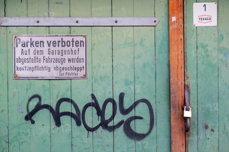 Photograph of a no parking sign attached to a wooden garage door, Hanover, Lower Saxony, Germany