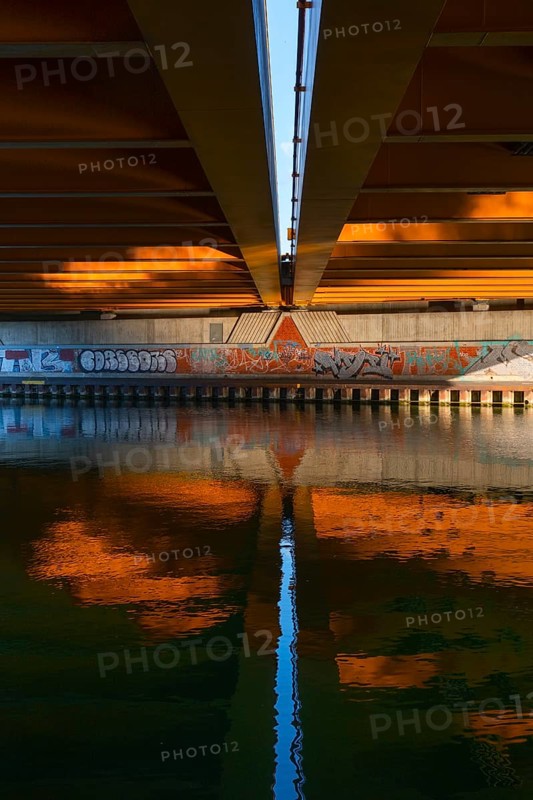 View across the Mittelland Canal to the underside and the graffiti-painted abutment of a bridge on the B6, Hanover, Lower Saxony, Germany
