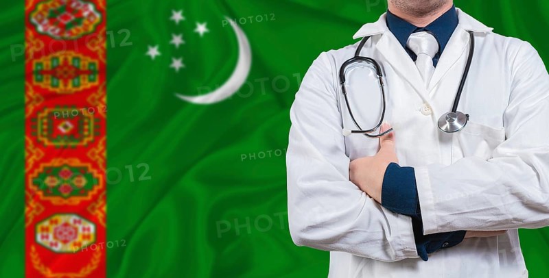 Male doctor with stethoscope on Turkmen flag. Doctor holding stethoscope on Turkmenistan flag