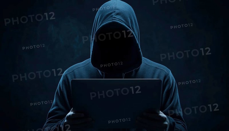 Dangerous Hooded Hacker Unleashing Internet, Cyber Crime, And Malware. Anonymous Figure Breaking Systems With Laptop In Dark, AI generated