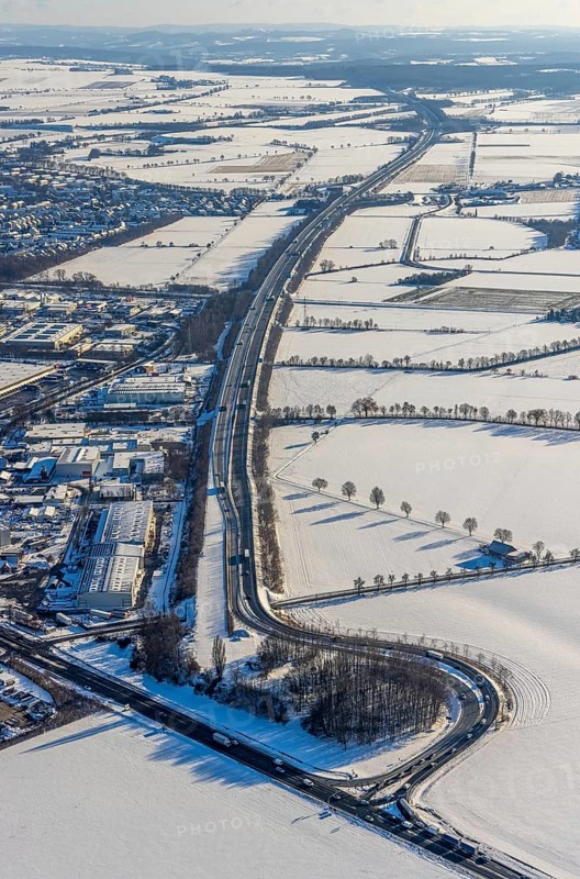 Aerial view, motorway access to the A445 motorway on the B63 Hammer Landstraße federal road, industrial area, commercial area, snow, winter, Budberg, Werl, Soester Börde, North Rhine-Westphalia, Germany, Soester, Börde, DE, Europe, birds-eyes, view, aerial photograph, aerial photography, aerial photography, overview, overview, bird's eye view, A445, B63, industry, commerce, economy, commercial enterprise, production, trade, manufacturing, transport, traffic, infrastructure, logistics, road traffic