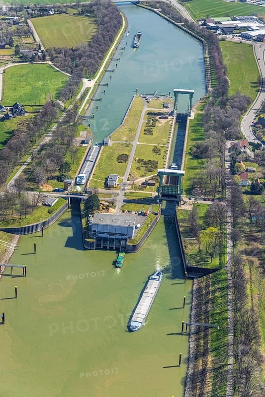 Aerial view, harbour Emmelsum, lock Friedrichsfeld, lock road, river Rhine, Rhine estuary Wesel-Datteln canal, Emmelsum, Voerde, Ruhr area, Lower Rhine, North Rhine-Westphalia, Germany, inland navigation, view to Büderich, DE, Europe, distant view, river, goods transport, goods traffic, harbour basin, canal, logistics, aerial view, aerial photography, aerial photography, estuary, ship, shipping pier, shipping traffic, lock, overview, bird's eye view, birds-eyes view, overview