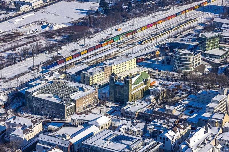 Aerial view, Unna railway station, catholic church St. Katharina, Unna, Ruhr area, North Rhine-Westphalia, Germany, place of worship, railway tracks, railway station, Bahnhofstraße, station forecourt, bus station, DE, Deutsche Bahn AG, Europe, gastronomy, religious community, railway tracks, place of worship, goods train, main station, main station, holy place, hotel, hotel facilities, hotel industry, Kantstraße, Katharinen Hof, church, parish, denomination, aerial view, aerial photography, aerial photography, religion, religious site, snow, overview, bird's-eye view, winter, onset of winter, winter landscape, ZOB, trains, birds-eyes view, overview