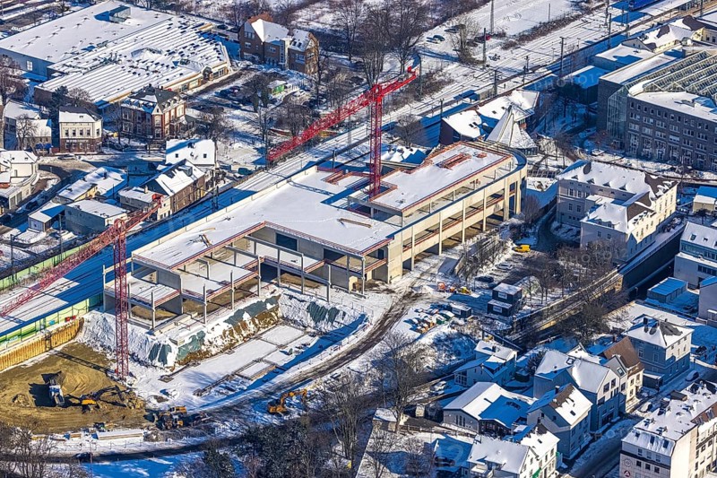 Aerial view, construction site new building shopping centre, former site Mühle Bremme, Unna, Ruhr area, North Rhine-Westphalia, Germany, construction work, construction area, construction site, building plots, construction measure, construction project, construction site, DE, shopping centre, Europe, Kantstraße, aerial view, aerial photography, aerial photography, new building, postal stairs, snow, overview, bird's eye view, winter, onset of winter, winter landscape, birds-eyes view, overview