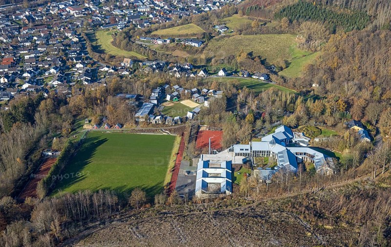 Aerial view, forest area with forest damage and sports and conference centre Hachen in the district Hachen in Sundern, Sauerland, North Rhine-Westphalia, Germany, tree dieback, bark beetle damage, bark beetle plague, DE, Europe, spruce dieback, clear-cutting, aerial view, aerial photography, aerial photography, sports field, sports centre, Sundern, overview, bird's eye view, forest, forest damage, forest dieback, birds-eyes view, overview