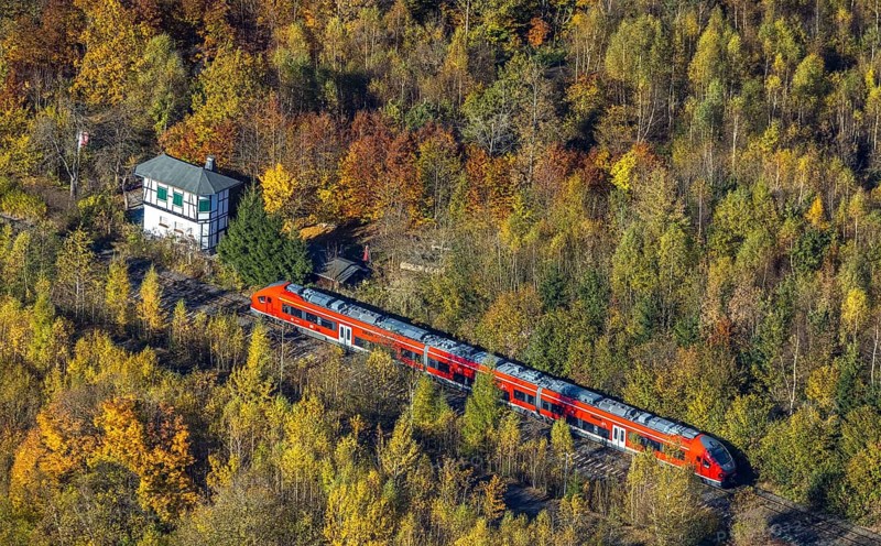 Aerial view, S-Bahn at a guard house in autumn forest in the district of Bigge in Olsberg, Sauerland, North Rhine-Westphalia, Germany, DE, Europe, shapes and colours, aerial view, aerial photography, aerial photography, Olsberg, local rail passenger transport, overview, bird's-eye view, overview