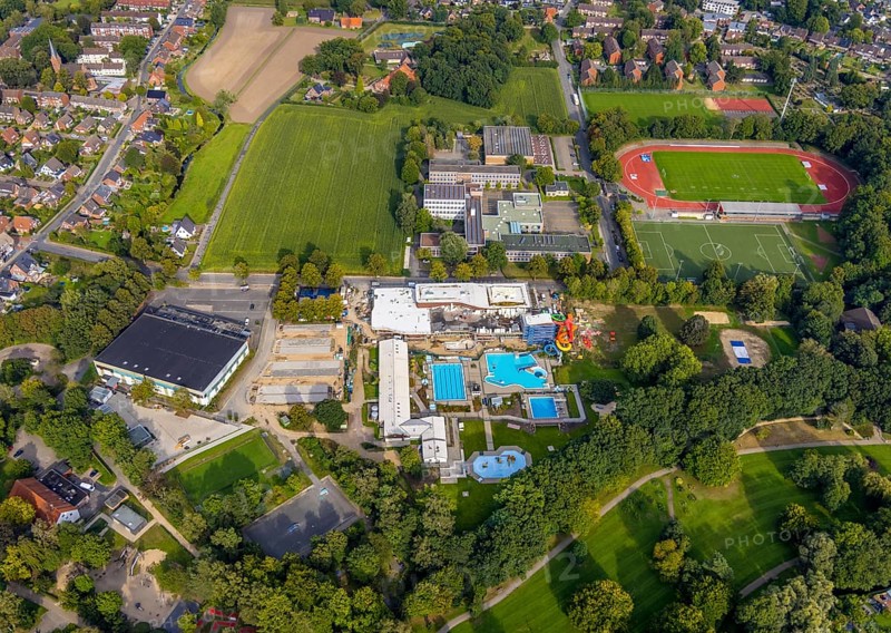 Aerial view, construction site and new construction of an indoor swimming pool at the Rheine outdoor swimming pool, Rheine ice rink, Kopernikus Gymnasium, Rheine evening high school and Jahnstadion in Rheine-Stadt in Rheine, Münsterland, North Rhine-Westphalia, Germany, bathing establishment, bathing resort, construction work, construction area, building site, building plots, construction measure, construction project, construction site, education, educational institution, DE, ice rink, Europe, outdoor swimming pool, football pitch, football stadium, grammar school, indoor swimming pool, educational institute, aerial view, aerial photography, aerial photography, new building, Rheine, school, swimming pool, sports, sports facilities, sports field, sports facility, overview, bird's-eye view, overview