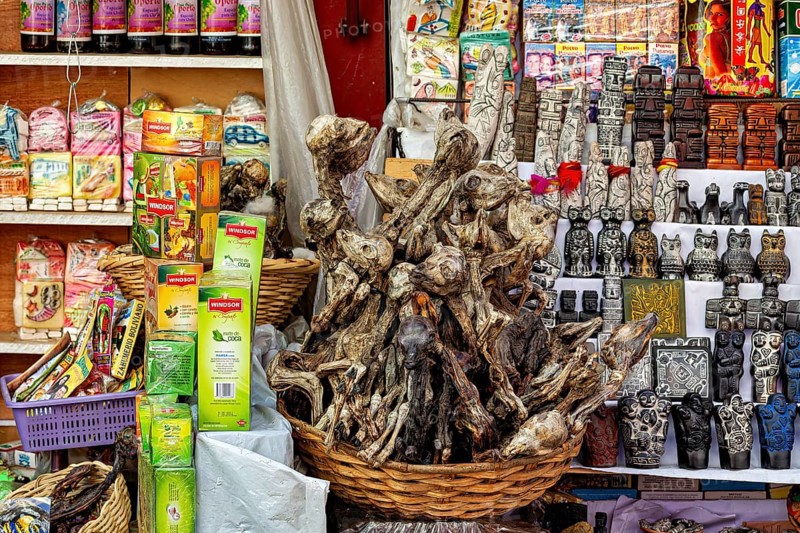 A market stall with dried animals and colourful packaging offers traditional decorative items, The witches' market in La Paz, Bolivia