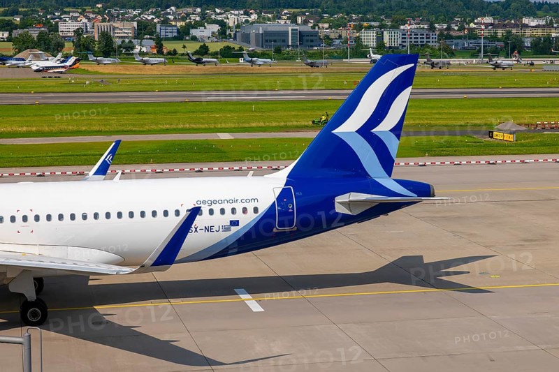 Aegean Airlines Passenger Airplane Taxiing on Runway in a Sunny Summer Day From the Airport in Kloten, Zurich, Zurich Canton, Switzerland