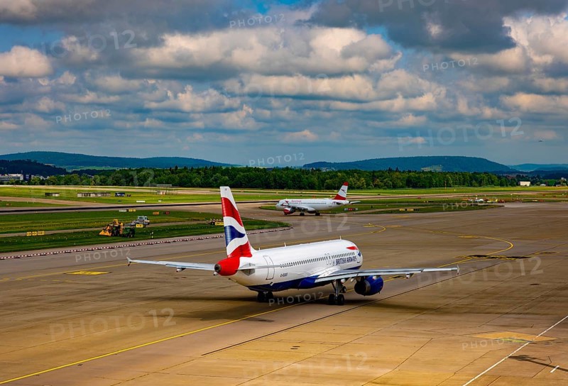 British Airways and Austrian Airlines Passenger Airplane Taxiing on Runway in a Sunny Summer Day From the Airport in Kloten, Zurich, Zurich Canton, Switzerland
