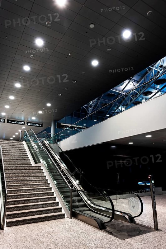 Inside Illuminated Zurich Airport with Escalator at Night in the Airport in Kloten, Zurich, Zurich Canton, Switzerland