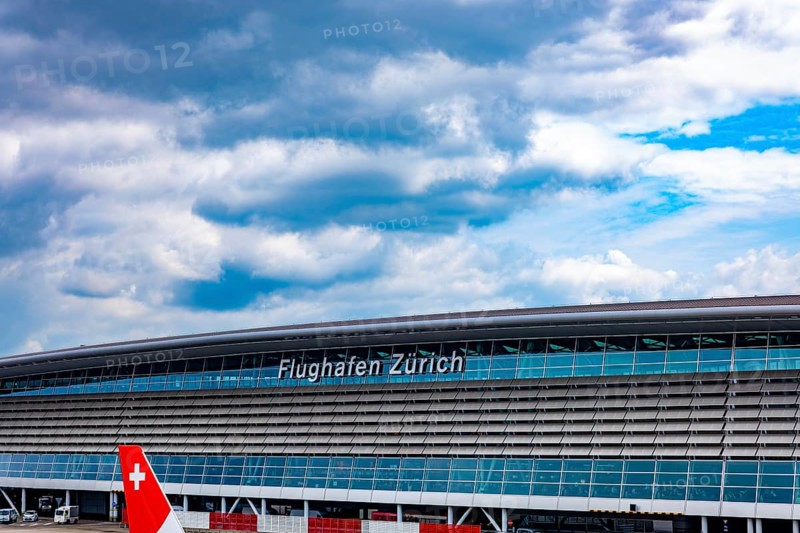 Zurich Airport and Building on Airfield in a Sunny Summer Day with Blue Sky and Clouds From the Airport in Kloten, Zurich, Zurich Canton, Switzerland